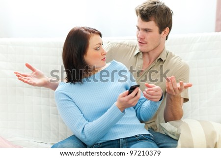 Angry girl checking boyfriends cell phone