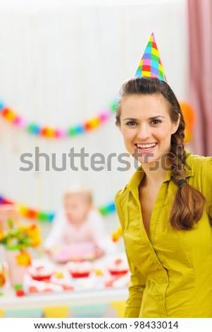 Portrait of smiling mom at baby birthday party