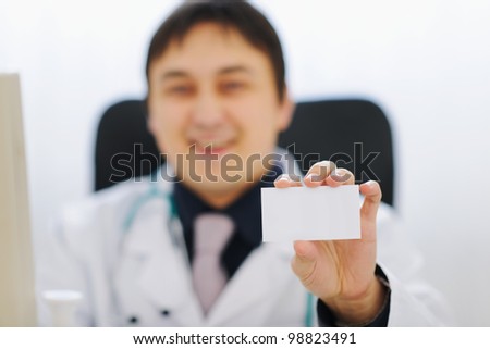 Closeup on business card in hand of medical doctor