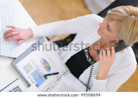 Mature business woman making phone call. Top view