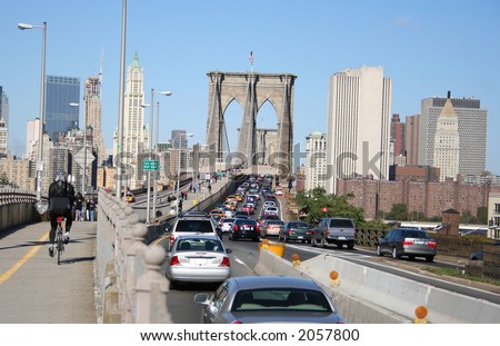 cyclist beating a rush hour traffic jam over the Brooklyn bridge
