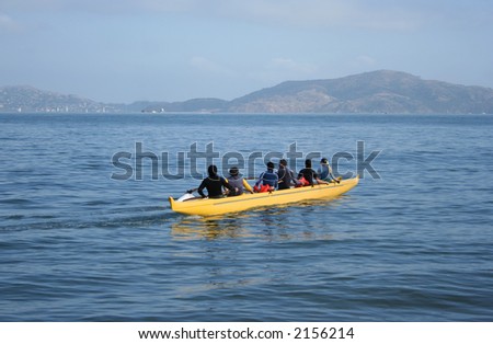 six people in a canoe with outrigger San Francisco bay