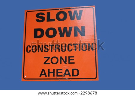 bright slow down construction zone ahead sign