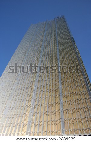 looking up at golden skyscraper from base