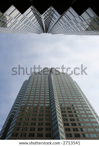 looking up at skyscraper from base on narrow street