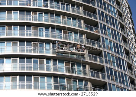 Window cleaners at work on residential skyscraper