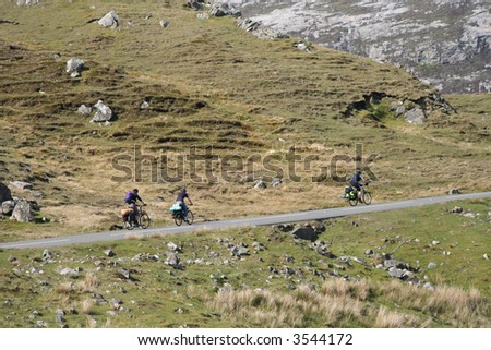 three cyclist cycling up a hill on the Isle of Harris Outer Hebrides Scotland
