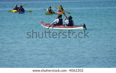 group of people kayaking in summer in turquoise waters