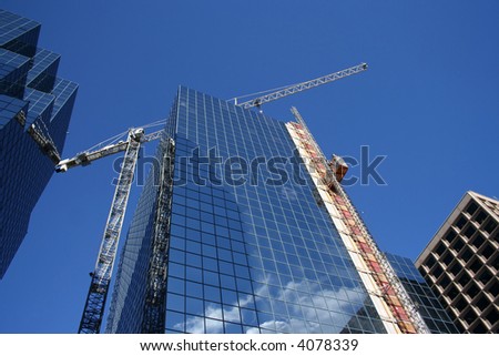 looking up at skyscrapers and construction crane