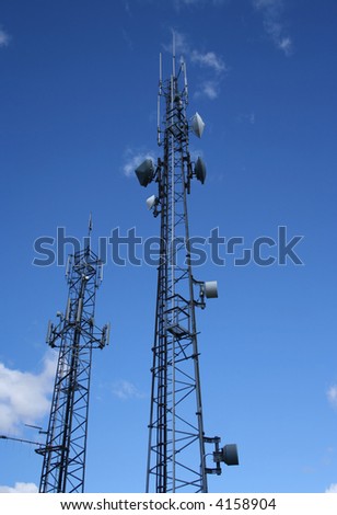 Looking up at pair of communication towers