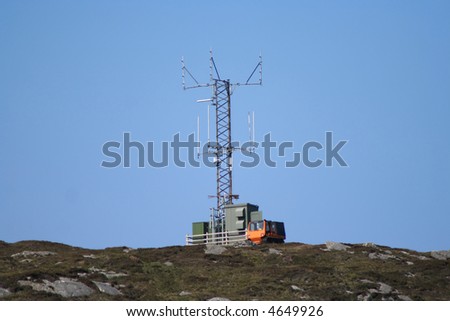 Communication tower on hill top with vehicle