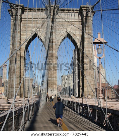 man jogging across Brooklyn Bridge New York City