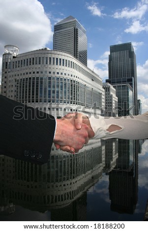 handshake between business people with London docklands skyline