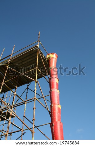 plastic debris chute and scaffolding at construction site