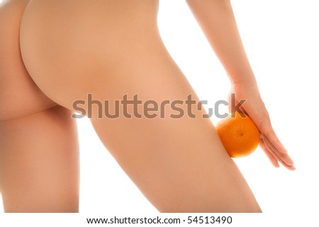 stock photo Naked woman's buttocks with orange