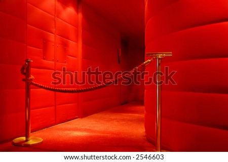 A red corridor to the stage in a theater
