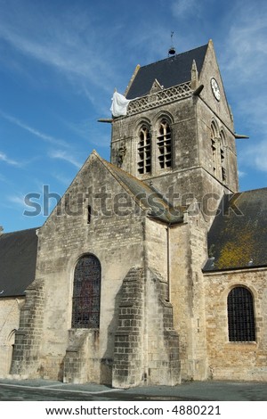 Sainte-Mère-Eglise was the first town liberated by the Allies.  The town was the scene of an incident where American paratrooper John Steele had his parachute caught on the spire of the church.