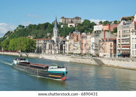 A boat on the river Saone running through the city of Lyon in France