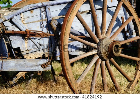 Old blue rusty cart abandonned in a field