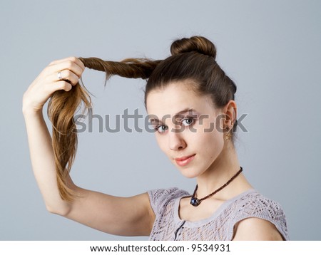 Girl with long twisted hair and a necklace on neck