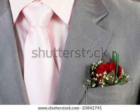 rose wedding boutonniere on suit of groom