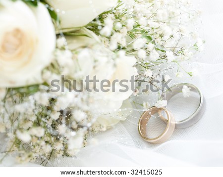 stock photo Closeup of wedding rings with flowers