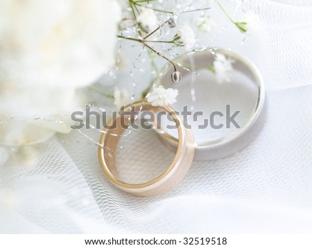 stock photo Closeup of wedding rings with flowers