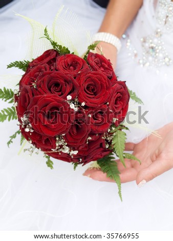 stock photo red wedding bouquet at bride's hands