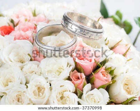 stock photo Closeup of wedding rings on flowers