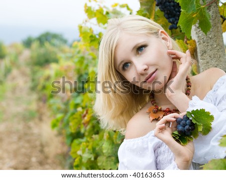 beautiful blonde girl in fall vineyard