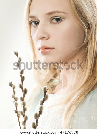 stock photo studio portrait of a beautiful girl with pussywillow buds
