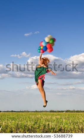 young happy girl in jumping with colorful balloons