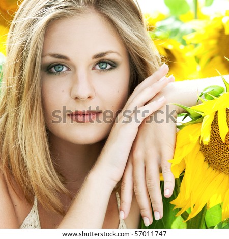 portrait of the beautiful happy girl with a sunflowers