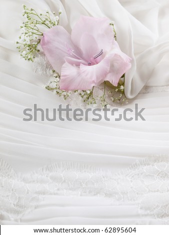 stock photo closeup shot of wedding dress with pink flower on it