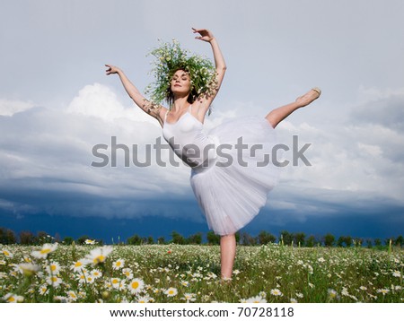 young beautiful ballet dancer against cloudy sky