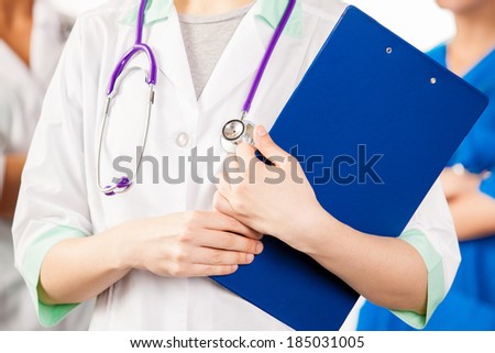 Doctors hands holding blue pad