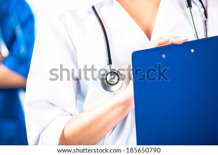 Doctors hands with blue pad