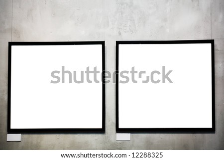 Two empty frames on cement wall in museum