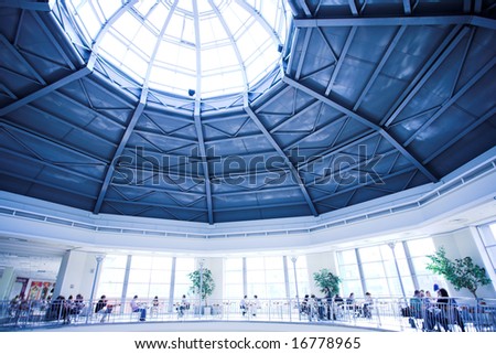 People silhouettes sit at modern office building