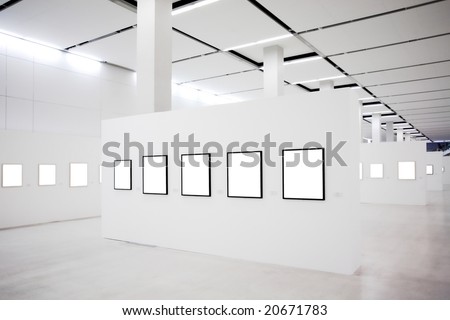 Exhibition in museum with many empty frames on white walls