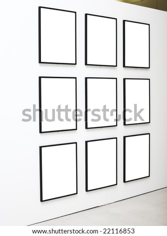 Nine empty frames on white wall exhibition in Museum