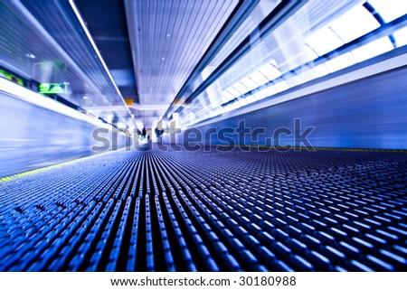 Camera lay on escalator view in violet corridor in office centre
