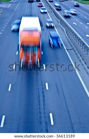 Traffic road with orange truck, motion blur