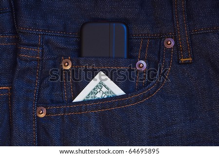 Mobile phone and one dollar banknote in jeans pocket