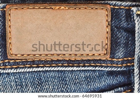 Blank leather label on blue jeans
