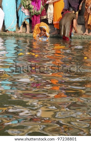 VARANASI-FEBRUARY 20: Hindu elderly woman worship the Ganges during the festivals Maha Shiva Ratri on February 20, 2012 Varanasi India. Maha Shiva Ratri is an Hindu festival celebrated every year.