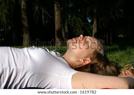 Young well-nourished woman dreaming at the forest