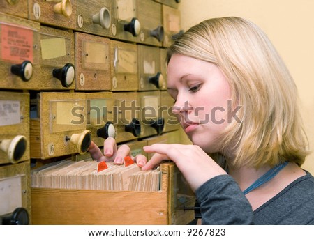 Student girl working with library card index