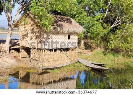 Traditional wooden stilt house and canoe at the Inle lake, Shan state, Myanmar (Burma)