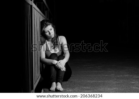 melancholy woman in a dark portrait